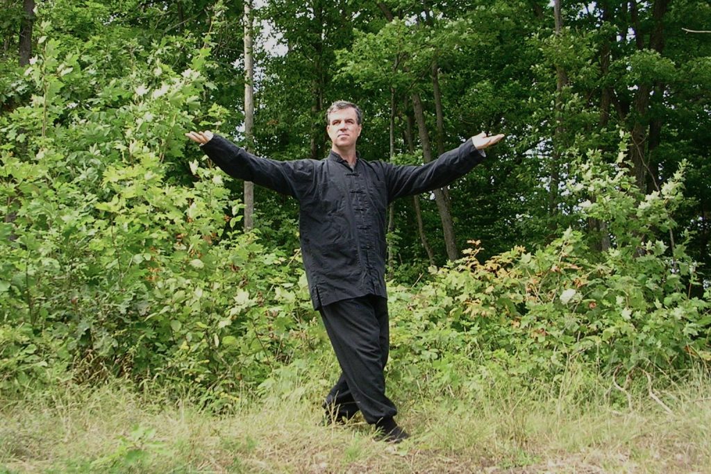 Practicing Qigong for health in a forest